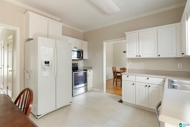 kitchen with sink, ornamental molding, white cabinets, and appliances with stainless steel finishes