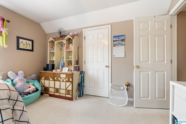 bedroom featuring vaulted ceiling and carpet