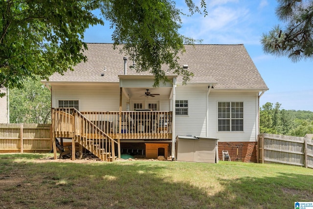 back of property featuring a wooden deck, a yard, and ceiling fan