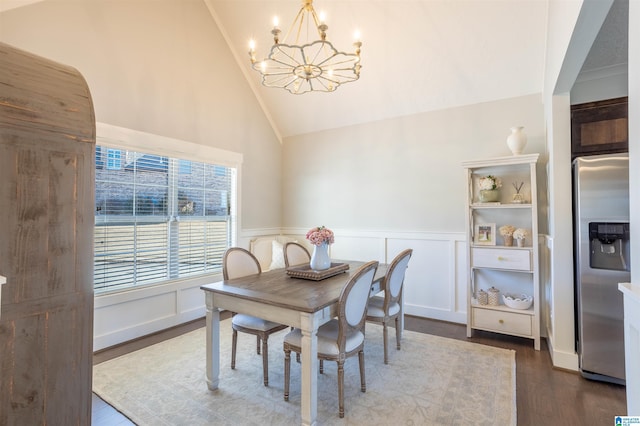 dining room with an inviting chandelier, dark hardwood / wood-style floors, and high vaulted ceiling