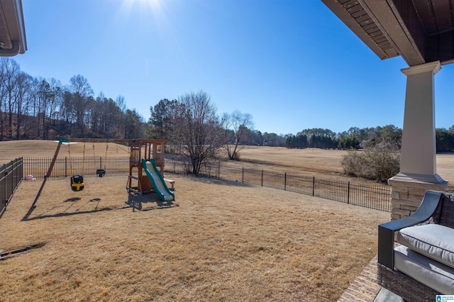 view of yard with a playground and a rural view