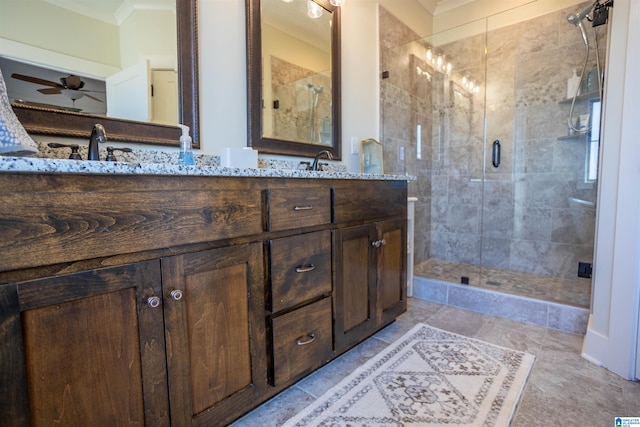 bathroom featuring crown molding, a shower with shower door, ceiling fan, and vanity