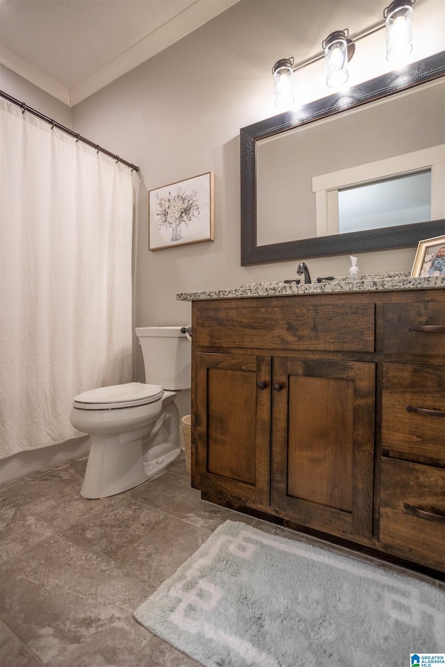 bathroom featuring toilet, vanity, and ornamental molding