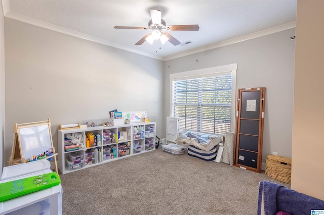 rec room featuring carpet floors, crown molding, and ceiling fan