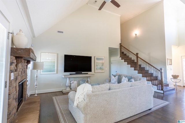 living room featuring a fireplace, high vaulted ceiling, ceiling fan, and dark hardwood / wood-style flooring