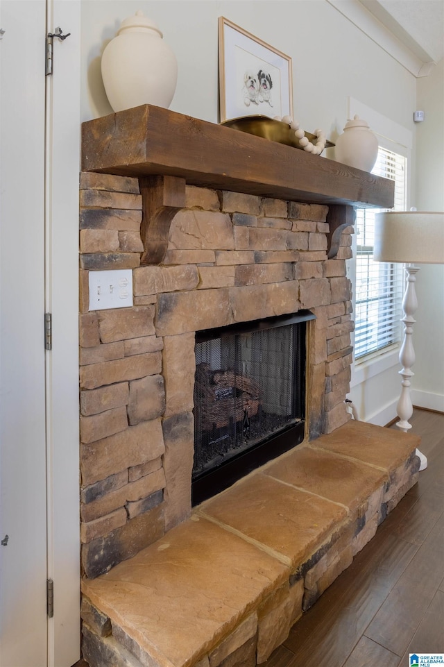 interior details featuring a stone fireplace and hardwood / wood-style floors