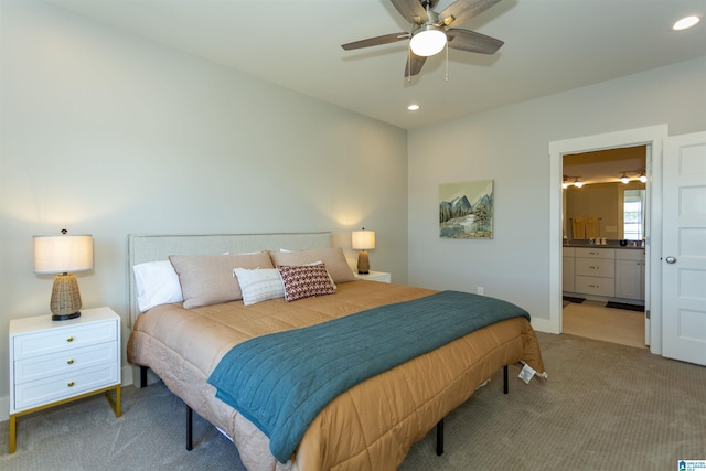 bedroom featuring ceiling fan, ensuite bathroom, and carpet flooring