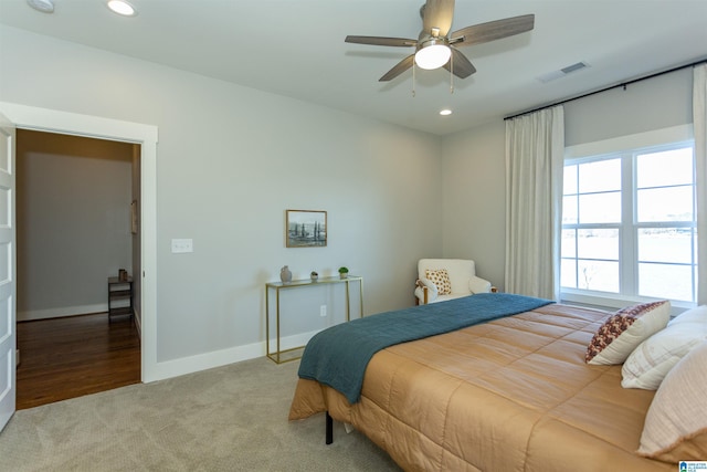 bedroom with light colored carpet and ceiling fan