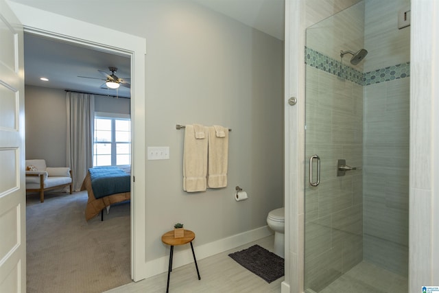 bathroom featuring an enclosed shower, ceiling fan, and toilet