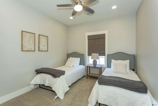 bedroom with light carpet and ceiling fan