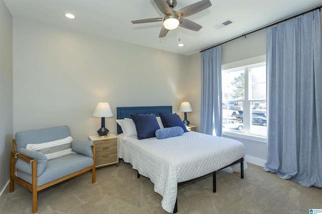 bedroom featuring ceiling fan, carpet, and multiple windows