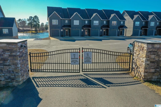 view of gate featuring a water view