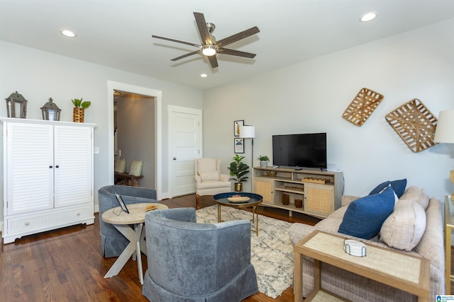 living room with dark hardwood / wood-style floors and ceiling fan