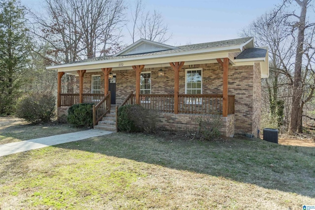 view of front of house with a front yard, central air condition unit, and a porch