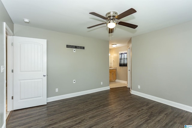 spare room with ceiling fan and dark hardwood / wood-style flooring