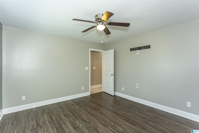 empty room featuring ceiling fan and dark hardwood / wood-style flooring