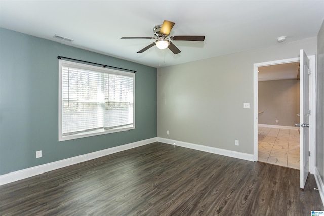 spare room with ceiling fan and dark hardwood / wood-style floors