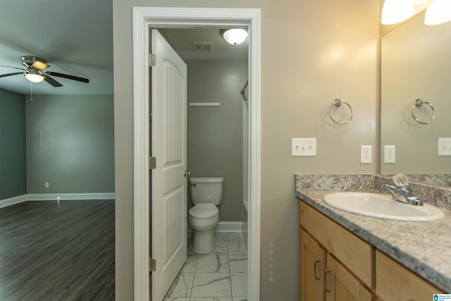 bathroom featuring vanity, toilet, and ceiling fan