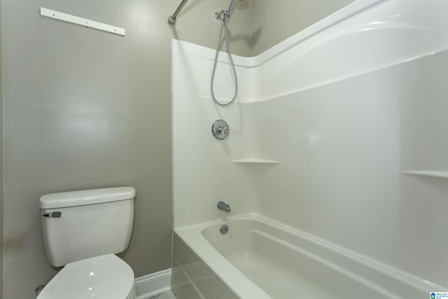 bathroom with bathing tub / shower combination and toilet