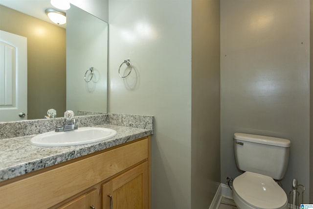 bathroom with toilet and vanity