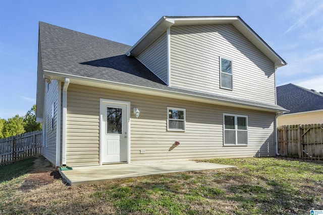 back of property with a patio area and a lawn