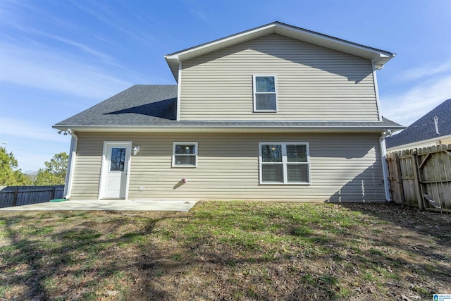 back of property featuring a patio area and a yard