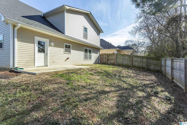 back of house featuring a patio area and a lawn