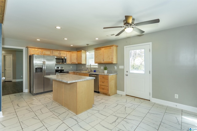 kitchen with pendant lighting, appliances with stainless steel finishes, a wealth of natural light, and a kitchen island