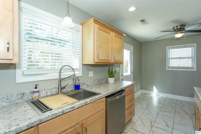 kitchen featuring light brown cabinetry, stainless steel dishwasher, sink, decorative light fixtures, and ceiling fan