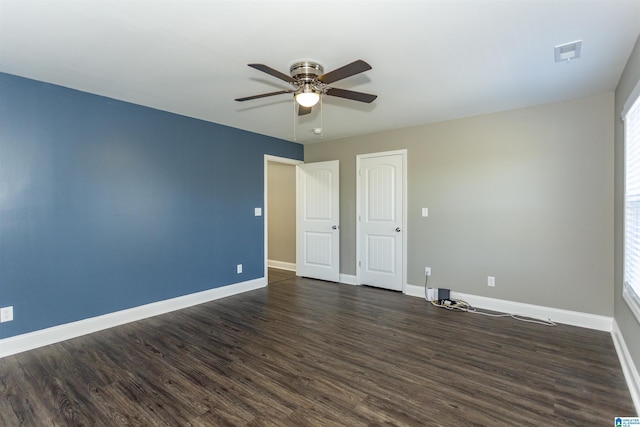 interior space with multiple windows, ceiling fan, and dark hardwood / wood-style flooring