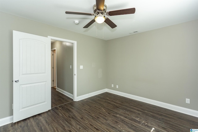 spare room with ceiling fan and dark hardwood / wood-style floors