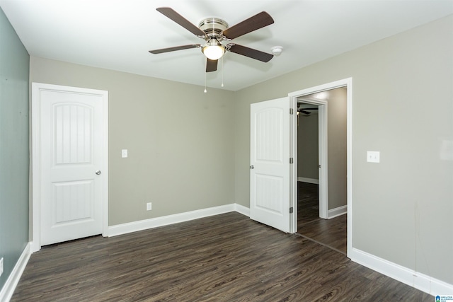 unfurnished bedroom featuring ceiling fan, dark hardwood / wood-style floors, and a closet