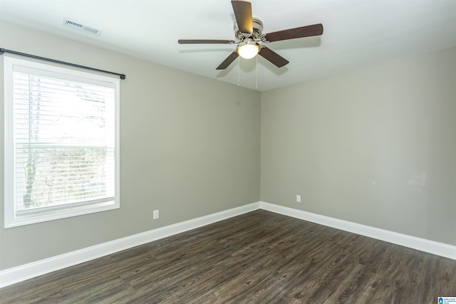 spare room featuring dark wood-type flooring and ceiling fan