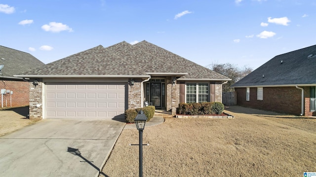 ranch-style house with a garage and a front yard