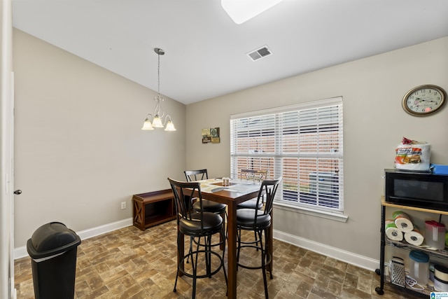 dining area with a notable chandelier