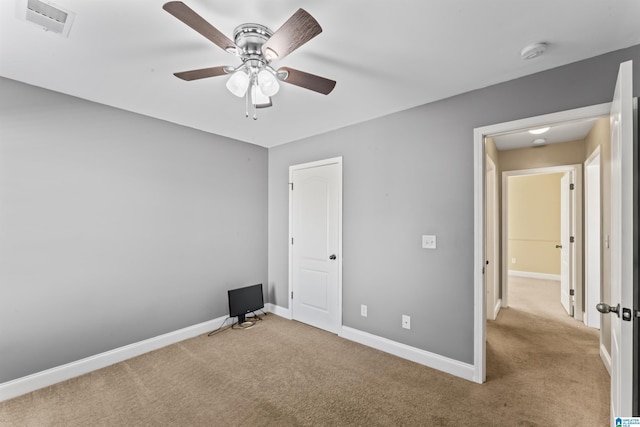 unfurnished bedroom with light colored carpet and ceiling fan