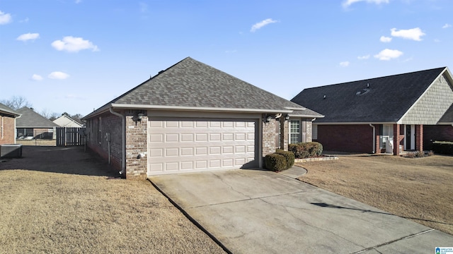 ranch-style home featuring a garage, central AC, and a front lawn