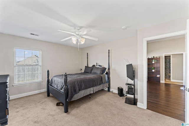 bedroom with ceiling fan and light carpet