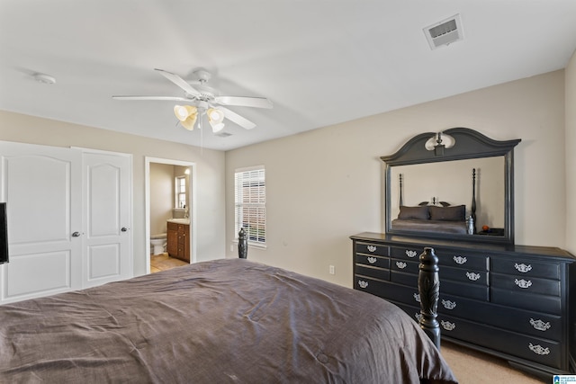 bedroom featuring ceiling fan and ensuite bath