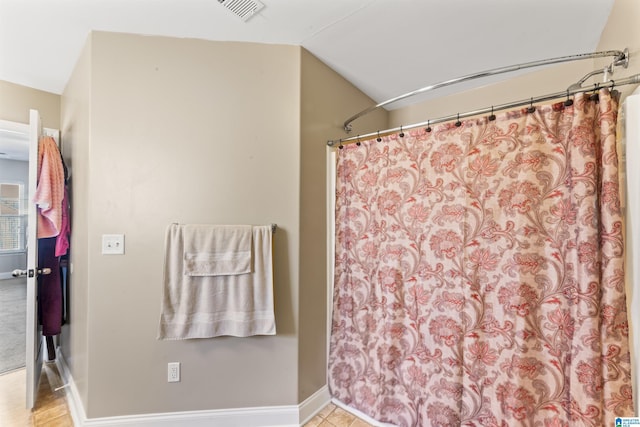 bathroom featuring vaulted ceiling