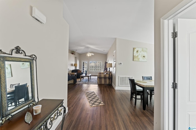 interior space featuring dark hardwood / wood-style flooring and vaulted ceiling