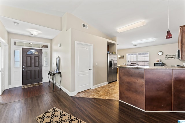 entrance foyer featuring hardwood / wood-style flooring and vaulted ceiling