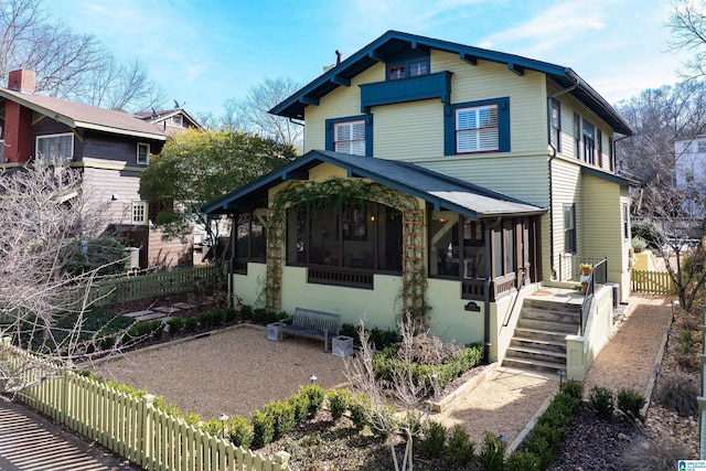 view of front of property with a patio area and a sunroom