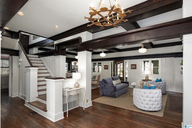 living room with ornate columns, dark hardwood / wood-style floors, a notable chandelier, and beam ceiling