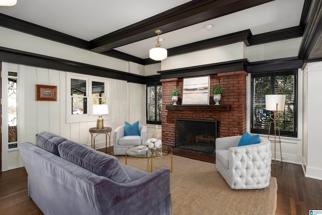 living room with beamed ceiling, a fireplace, dark hardwood / wood-style floors, and crown molding