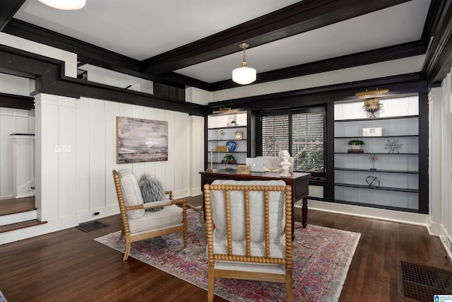 sitting room with beamed ceiling, ornamental molding, dark hardwood / wood-style flooring, and built in features