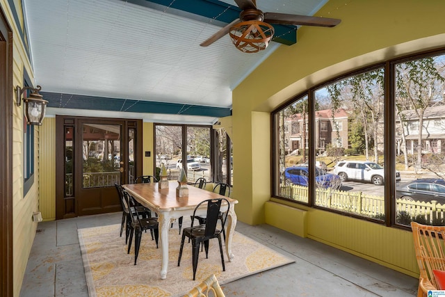 sunroom featuring vaulted ceiling and ceiling fan