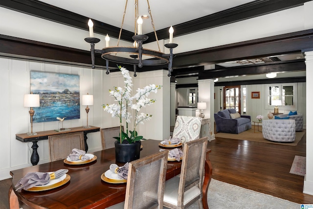 dining room with hardwood / wood-style flooring, ornamental molding, a chandelier, and ornate columns