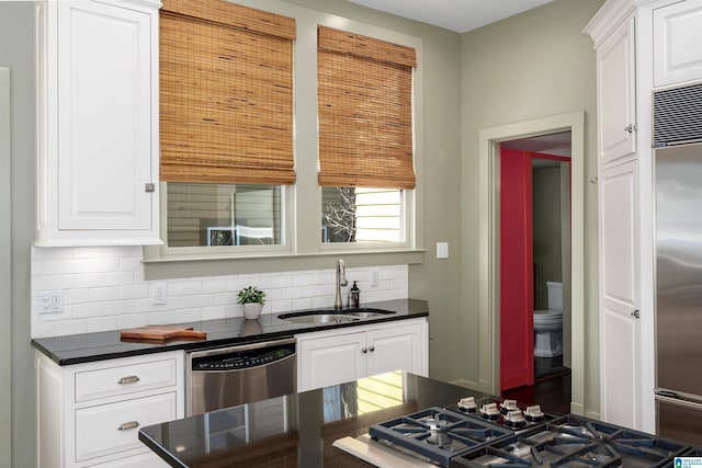 kitchen featuring stainless steel appliances, sink, and white cabinets