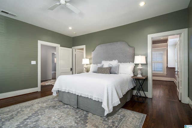 bedroom with dark hardwood / wood-style flooring and ceiling fan